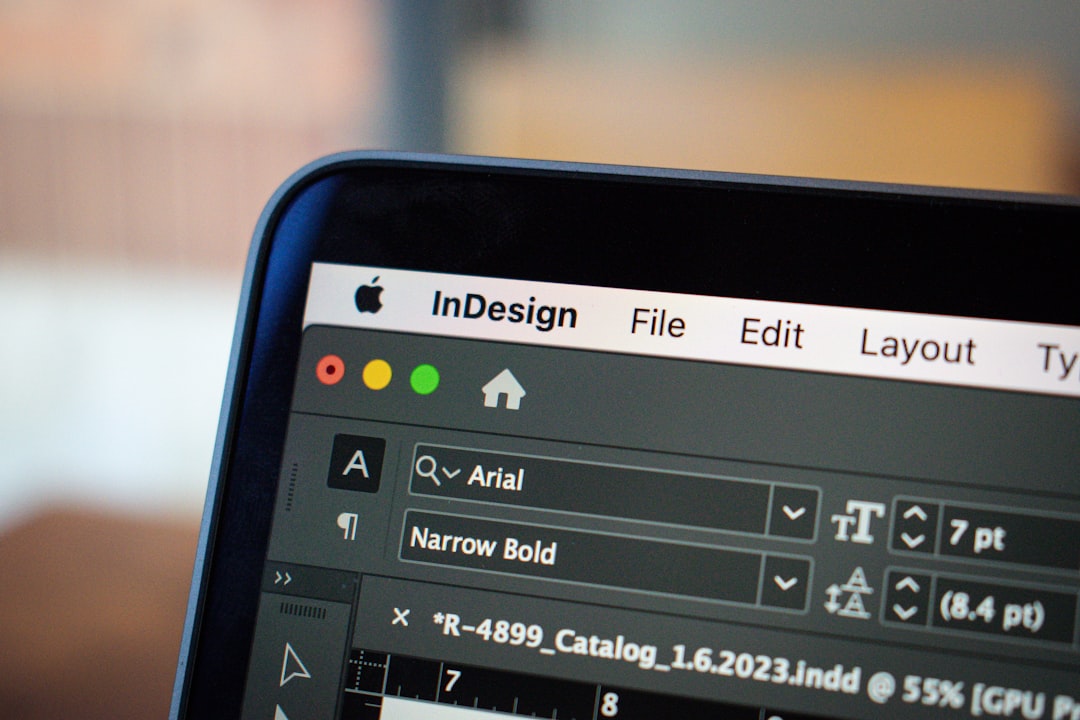 This close-up image showcases a MacBook Pro screen displaying an open project in Adobe InDesign. The focus is on the detailed interface of InDesign, with various design elements and toolbars visible, illustrating the softwares functionality in graphic design and layout creation. The MacBook Pros sleek design and high-resolution screen are highlighted, emphasizing the clarity and precision with which creative projects can be developed and viewed on this device.